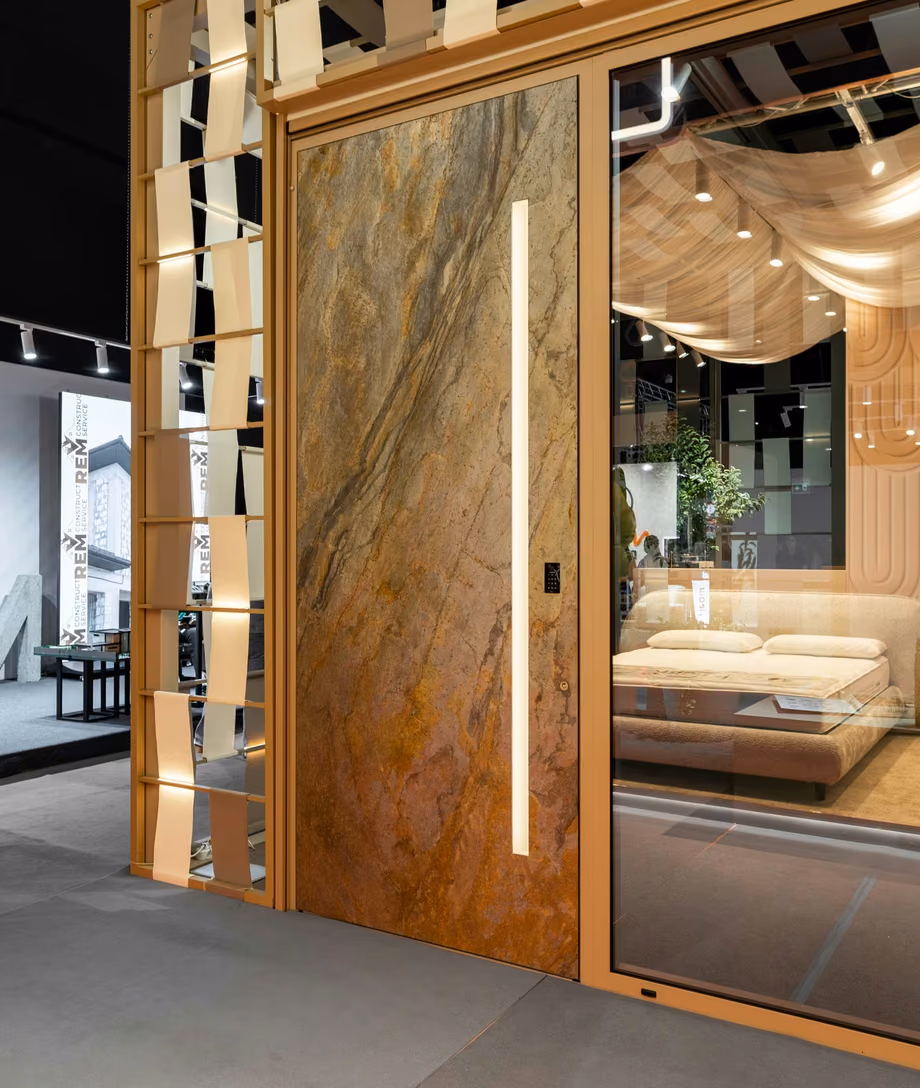Plastregal exhibition stand with a stone-look door panel, expansive glazing and a decorative timber structure.