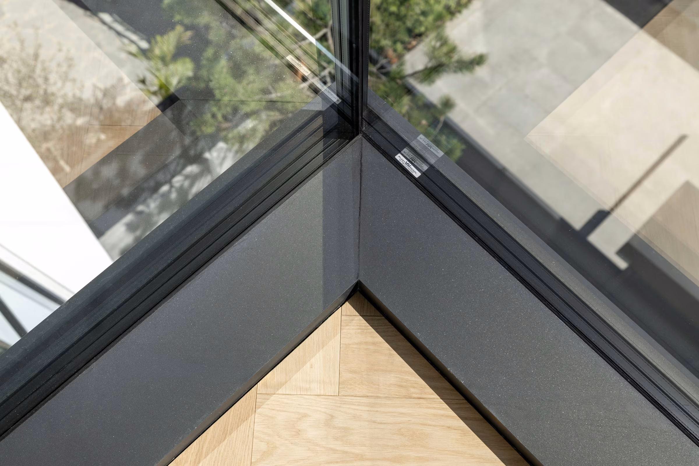 Top-down view of a 90-degree junction between two glazed surfaces.
