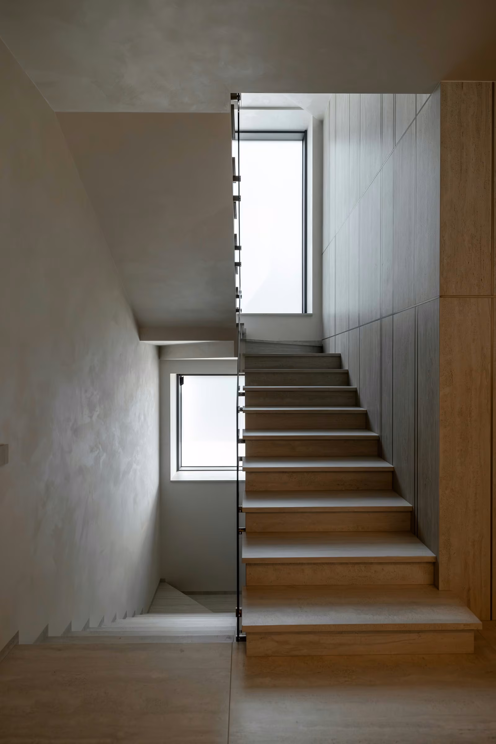 Front view of an interior staircase with windows at two different levels.