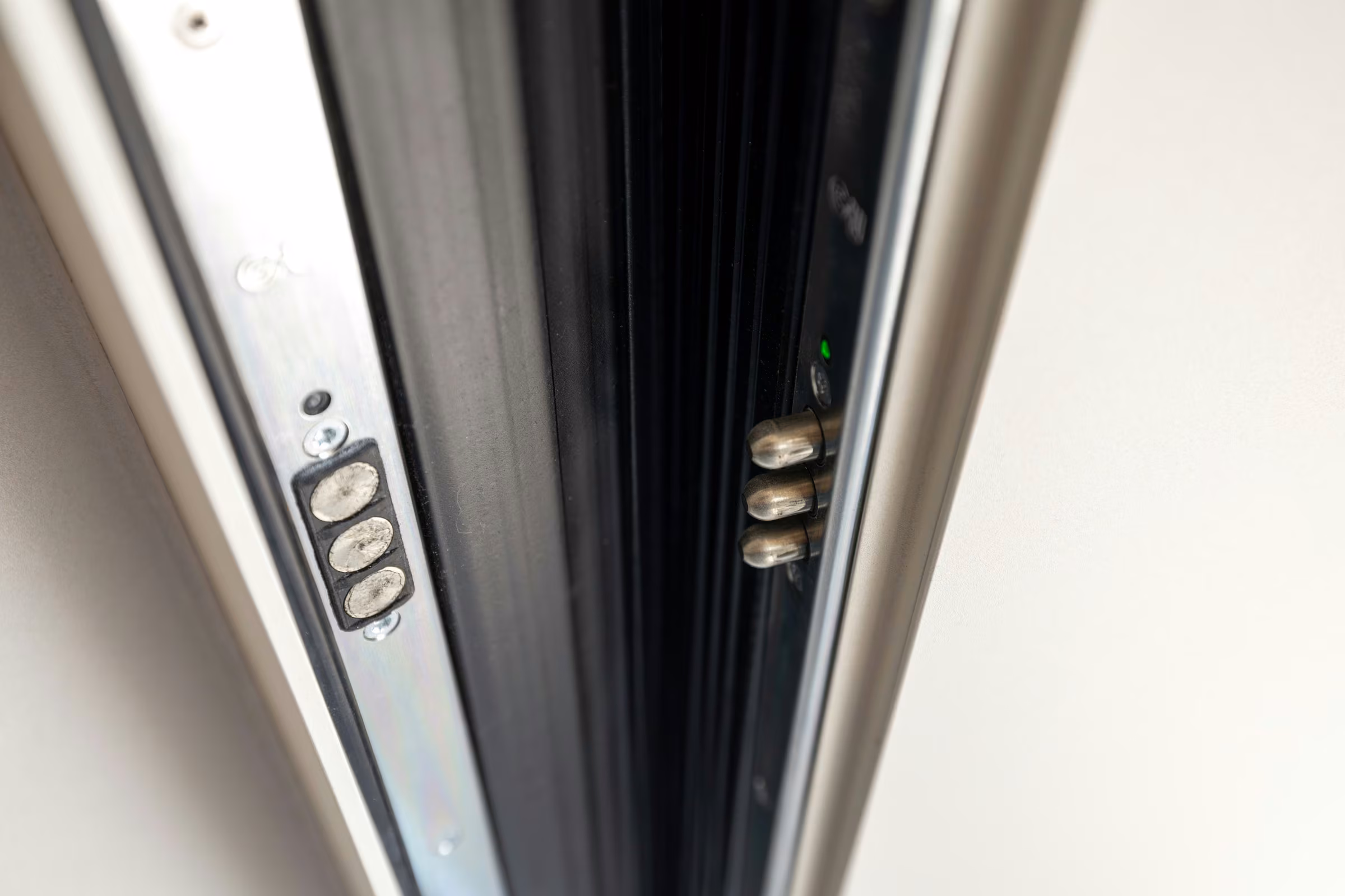 Close-up of metal locking components inside a door frame.