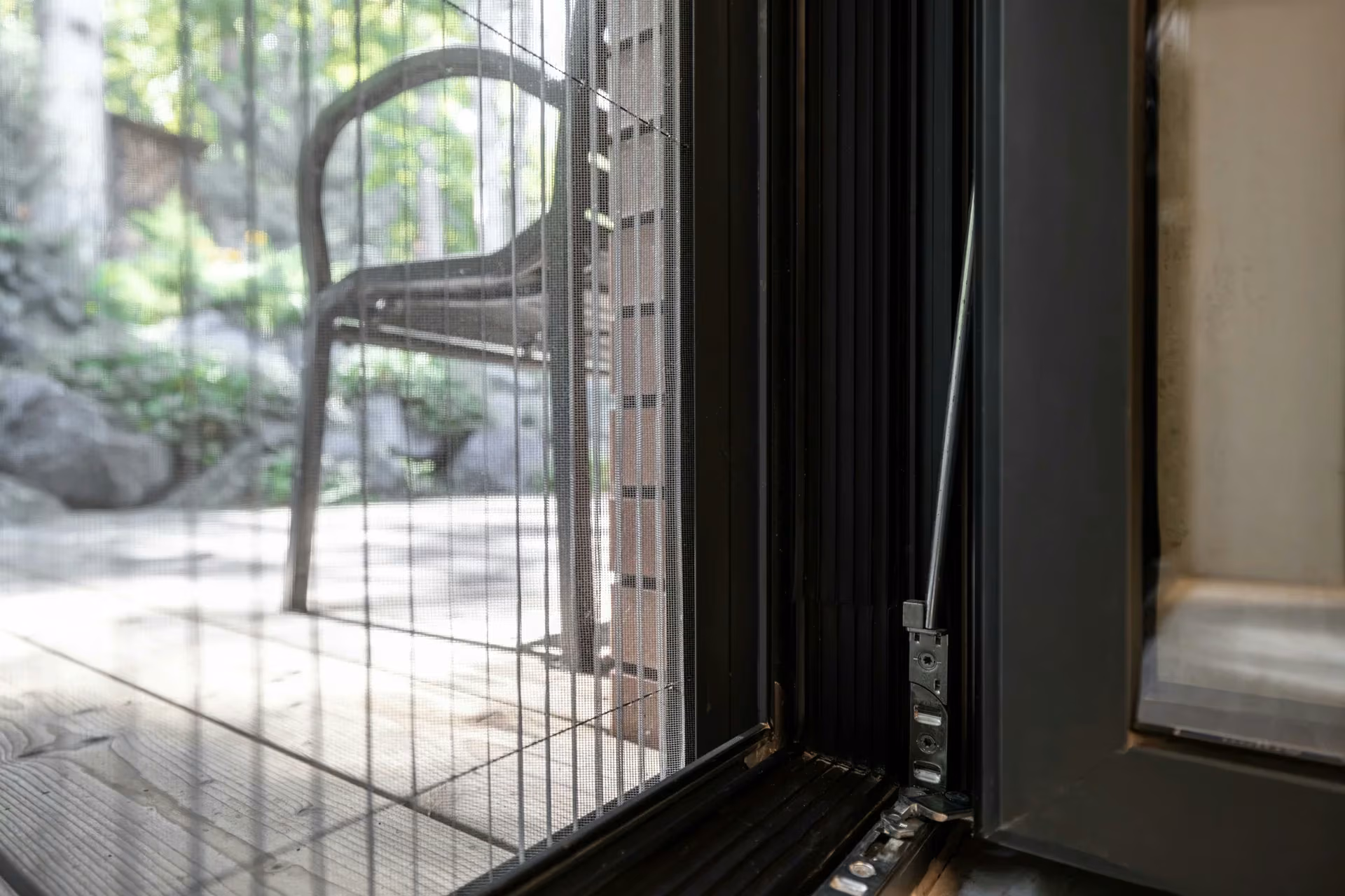 Detail of an insect screen and aluminium frame beside the terrace exit.
