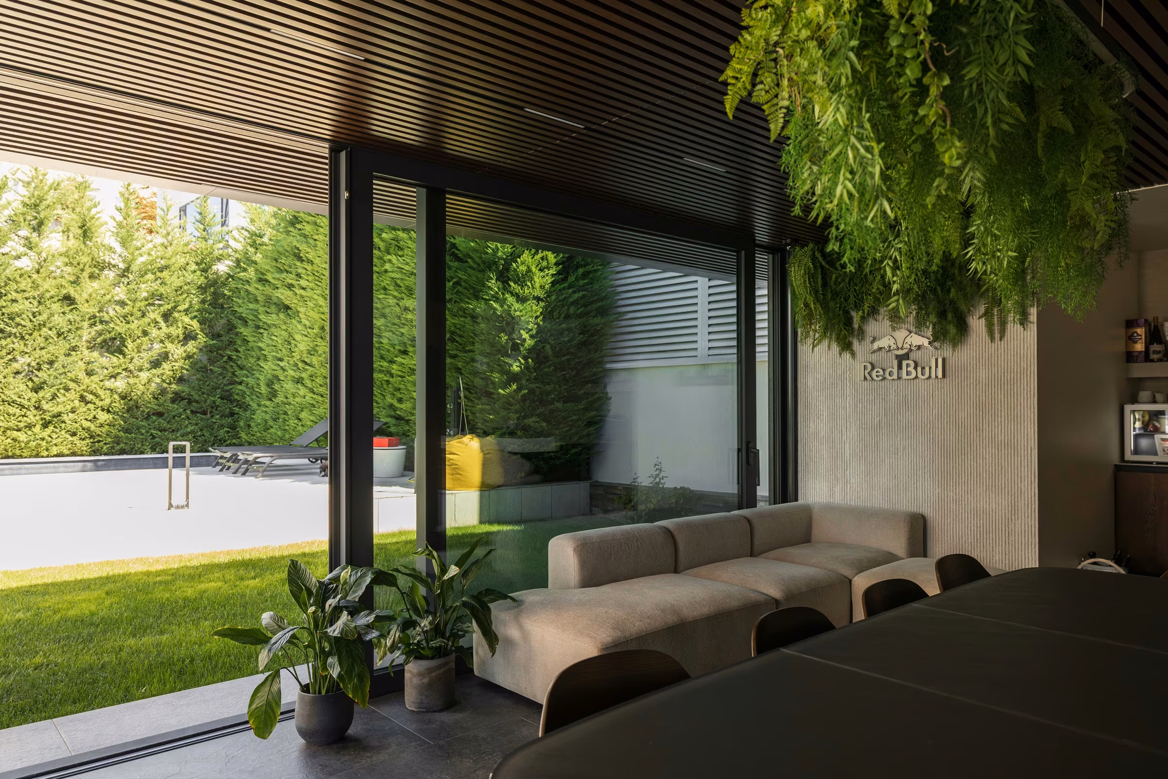 View of the terrace glazing with vertical frames and reflective glass surfaces.