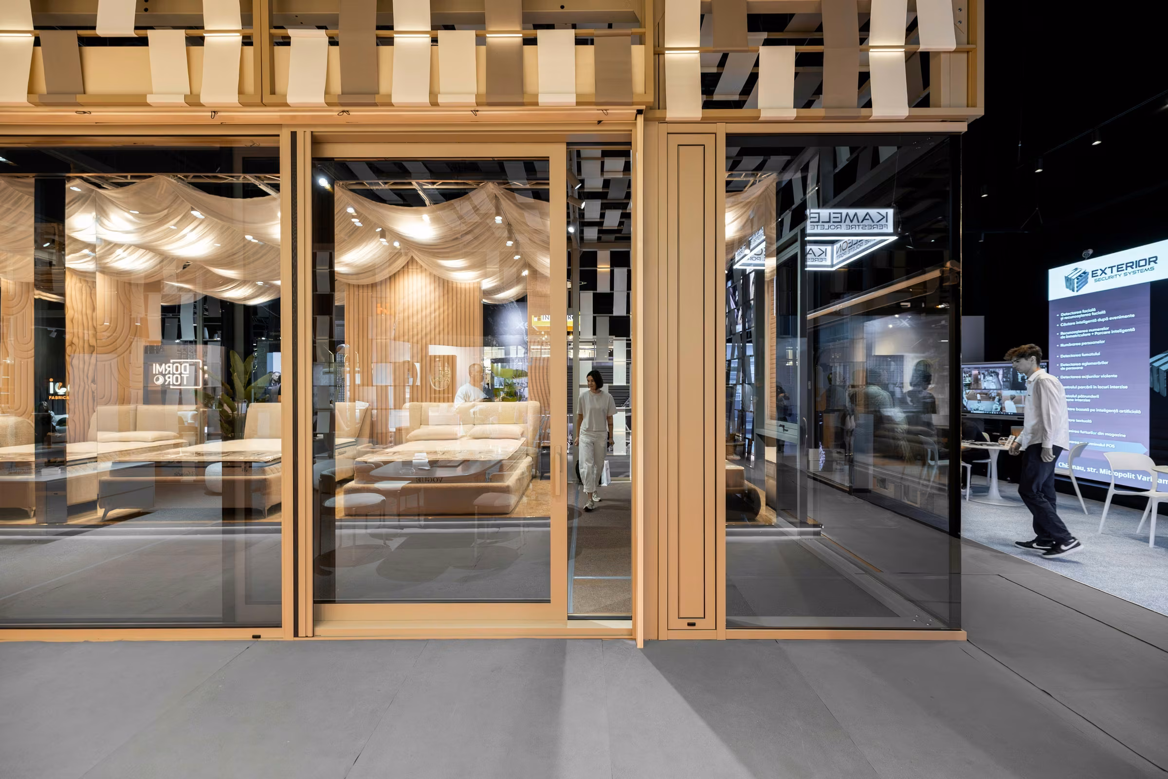 Front view of the stand's glazed systems, with glass panels and doors integrated into the composition.